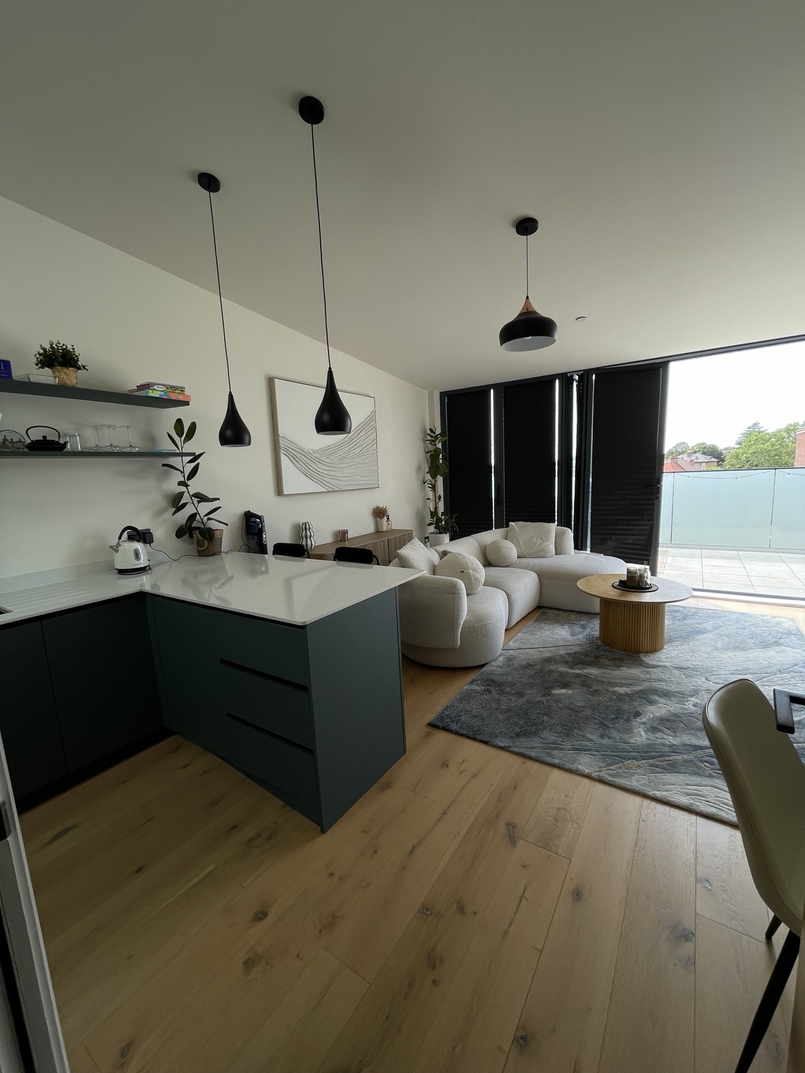 A personally cared-for open-plan home with a kitchen island and a light-filled living space, from Sylvia’s work.